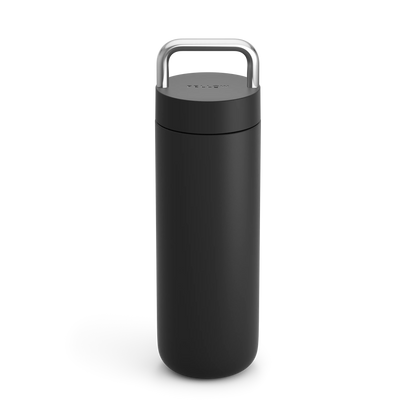 Fellow Carter Carry Travel Mug in matte black with silver handle, standing upright.
