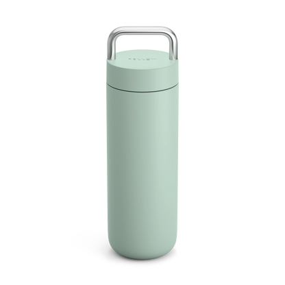 Fellow Carter Carry Travel Mug in light green with a silver handle, minimalist design.