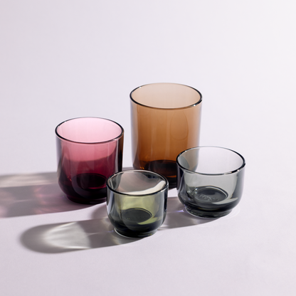 Six Pirch Espresso Glasses by Fellow in pink, brown, and gray on a light surface with shadows.