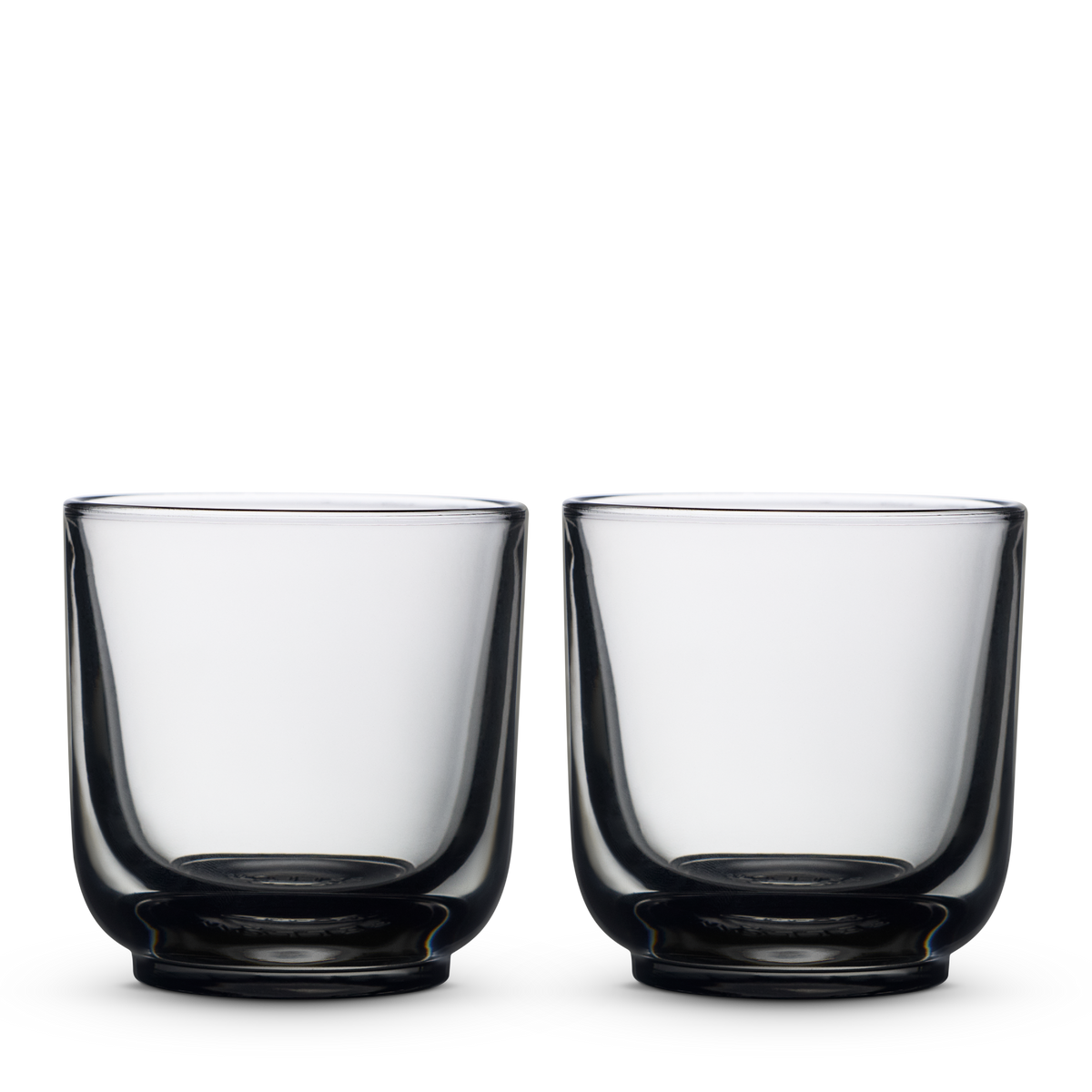 Two Fellow Pirch Espresso Glasses in Smoke shown side by side on a white background.
