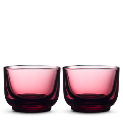 Two Fellow Pirch Espresso Glasses in garnet sit side by side on a white background.