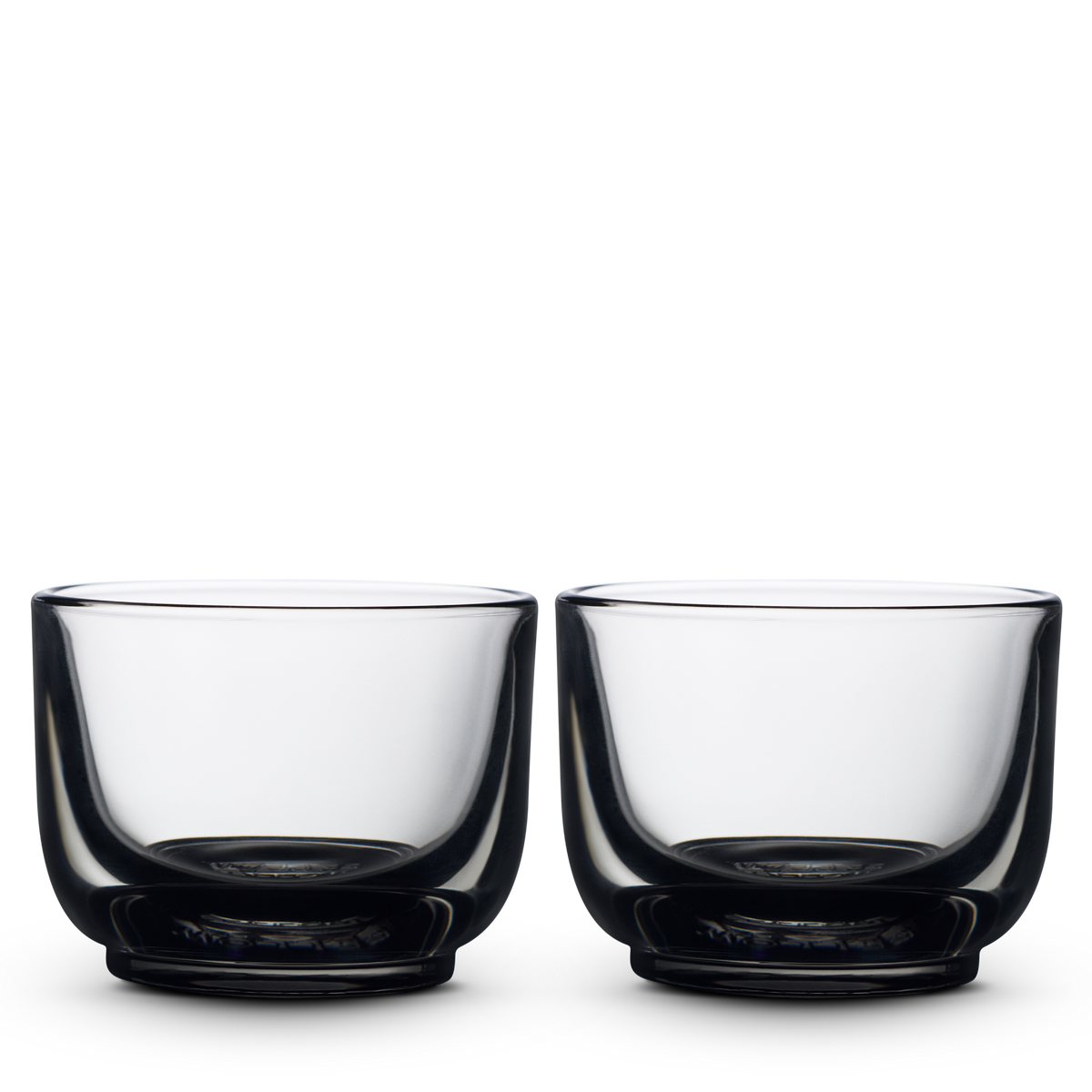 Two smoke Pirch Espresso Glasses by Fellow sit side by side on a plain white background.