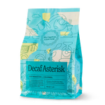 A blue Decaf Asterisk coffee bag by Olympia Coffee Roasting Company with Colombian art.