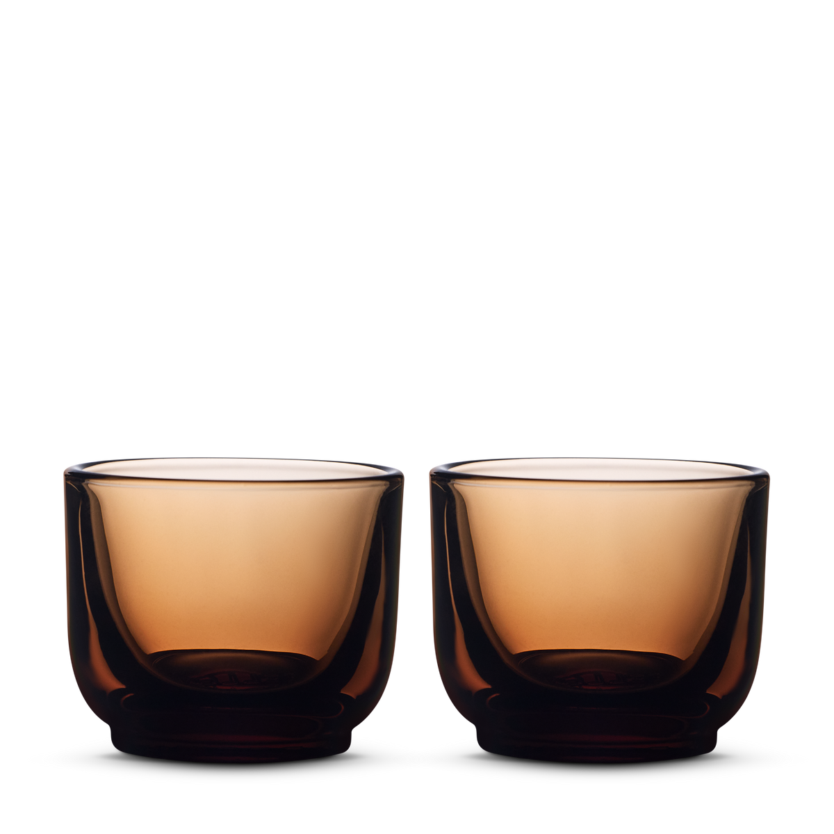 Two Fellow Pirch Espresso Glasses in amber are displayed side by side on a white background.