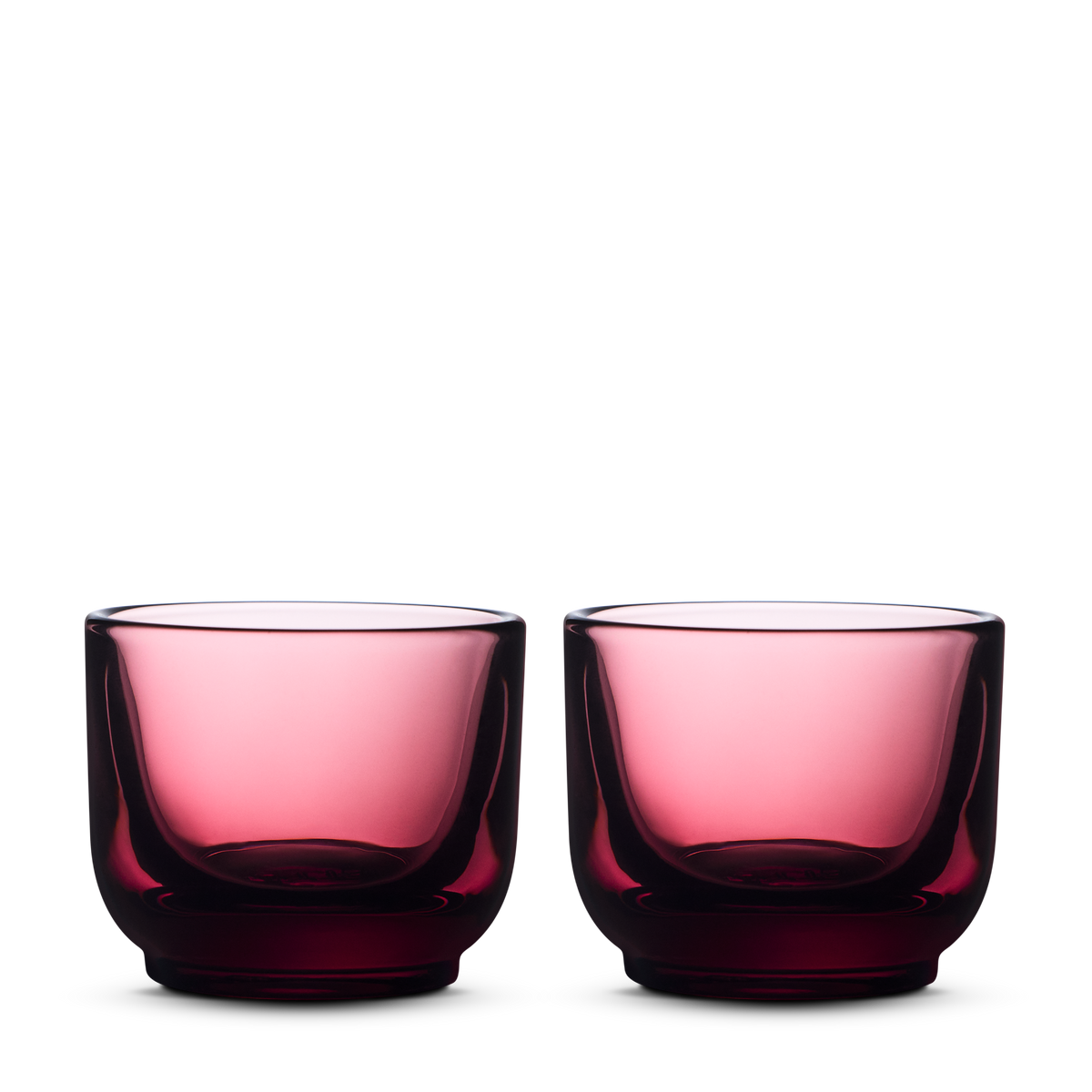 Two round Fellow Pirch Espresso Glasses in garnet on a plain white background.