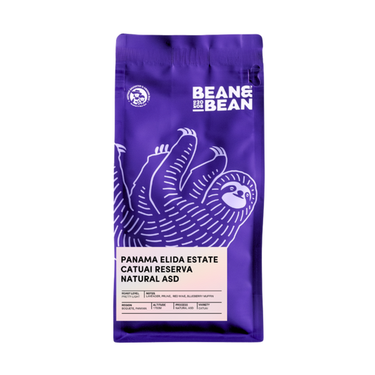 Purple coffee bag with a smiling sloth and Bean & Bean Panama Elida Estate label on front.