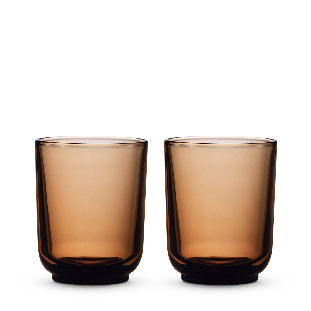 Two amber Pirch Espresso Glasses by Fellow side by side on a white background.
