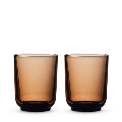 Two amber Pirch Espresso Glasses by Fellow side by side on a white background.