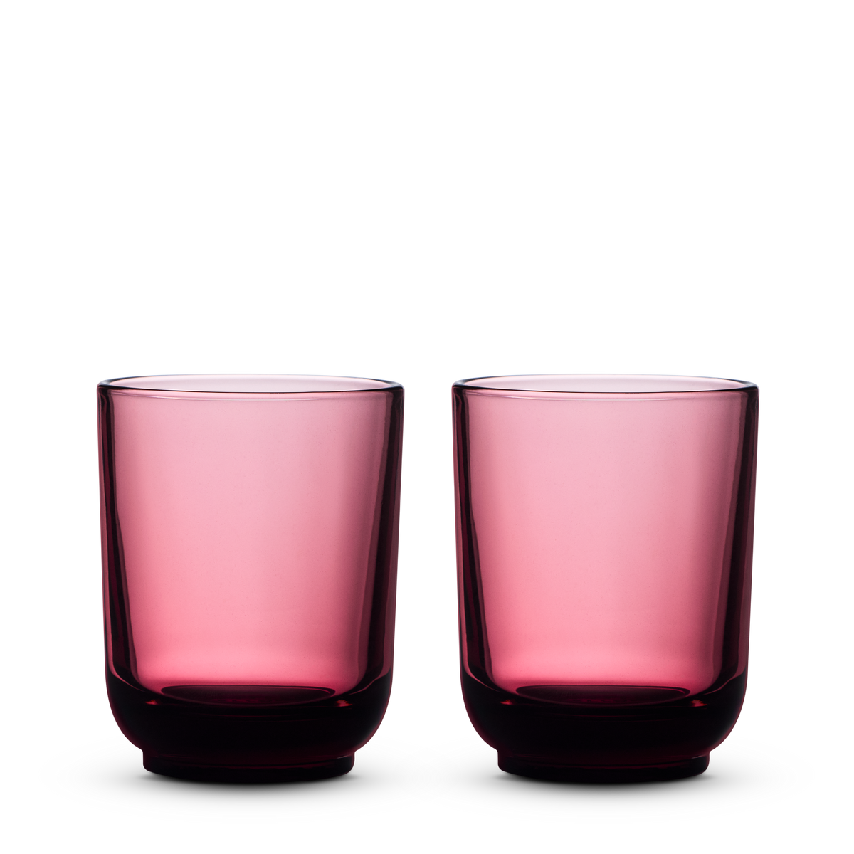 Two Fellow Pirch Espresso Glasses in Garnet side by side on a white background.