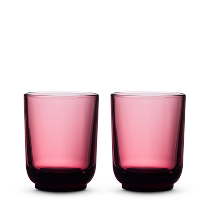 Two Fellow Pirch Espresso Glasses in Garnet side by side on a white background.