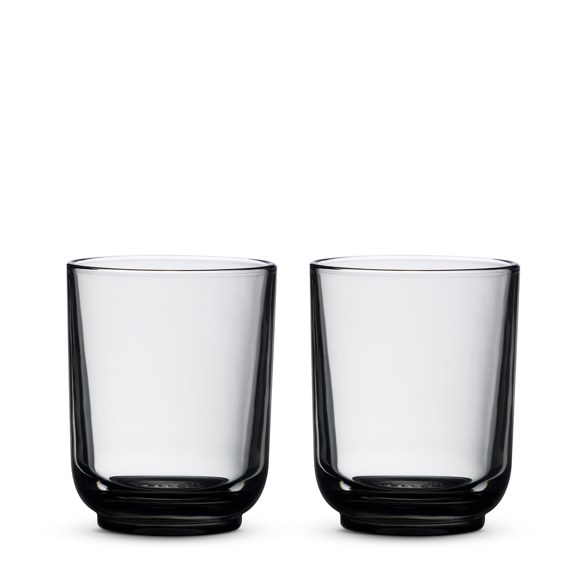 Two empty Fellow Pirch Espresso Glasses in Smoke side by side on a plain white background.