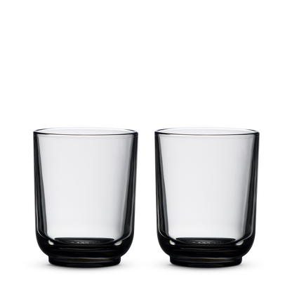 Two empty Fellow Pirch Espresso Glasses in Smoke side by side on a plain white background.
