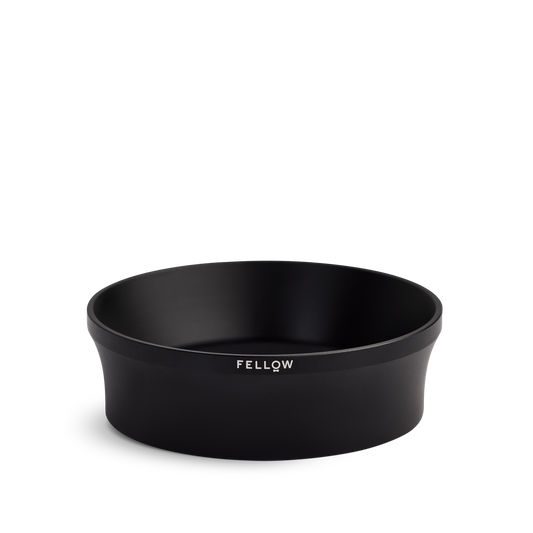 Fellow Espresso 58 mm Magnetic Dosing Funnel, black and round with logo on the side.