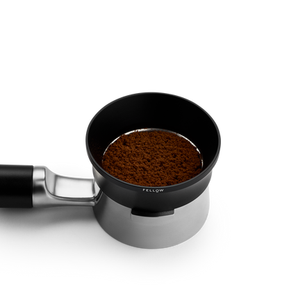 Fellow Espresso 58 mm Magnetic Dosing Funnel fits 58 mm portafilters; shown with coffee grounds.