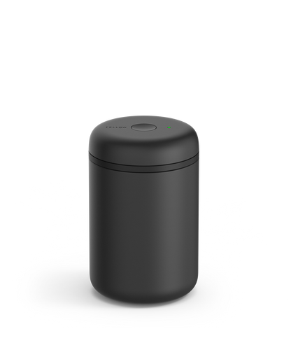 Fellow Atmos Vacuum Canister in matte black with a round lid and small top button.