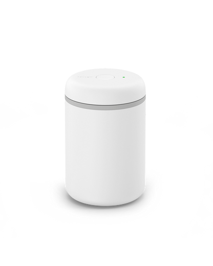 The Fellow Atmos Vacuum Canister is a small white canister with button, great for coffee beans.