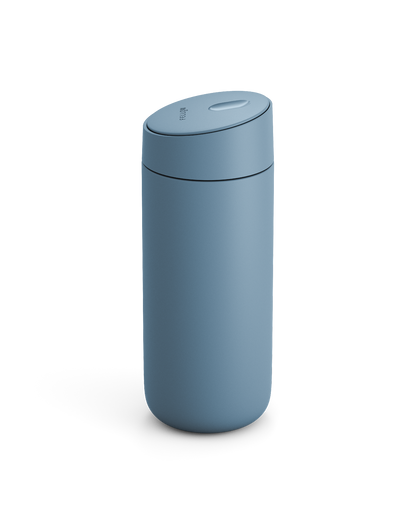 The Fellow Carter Slide Mug is a matte blue travel mug with a rounded lid, shown on white.