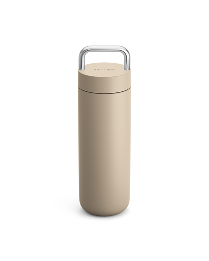 Fellow Carter Carry Travel Mug in Sand Dune with silver handle on a white background.