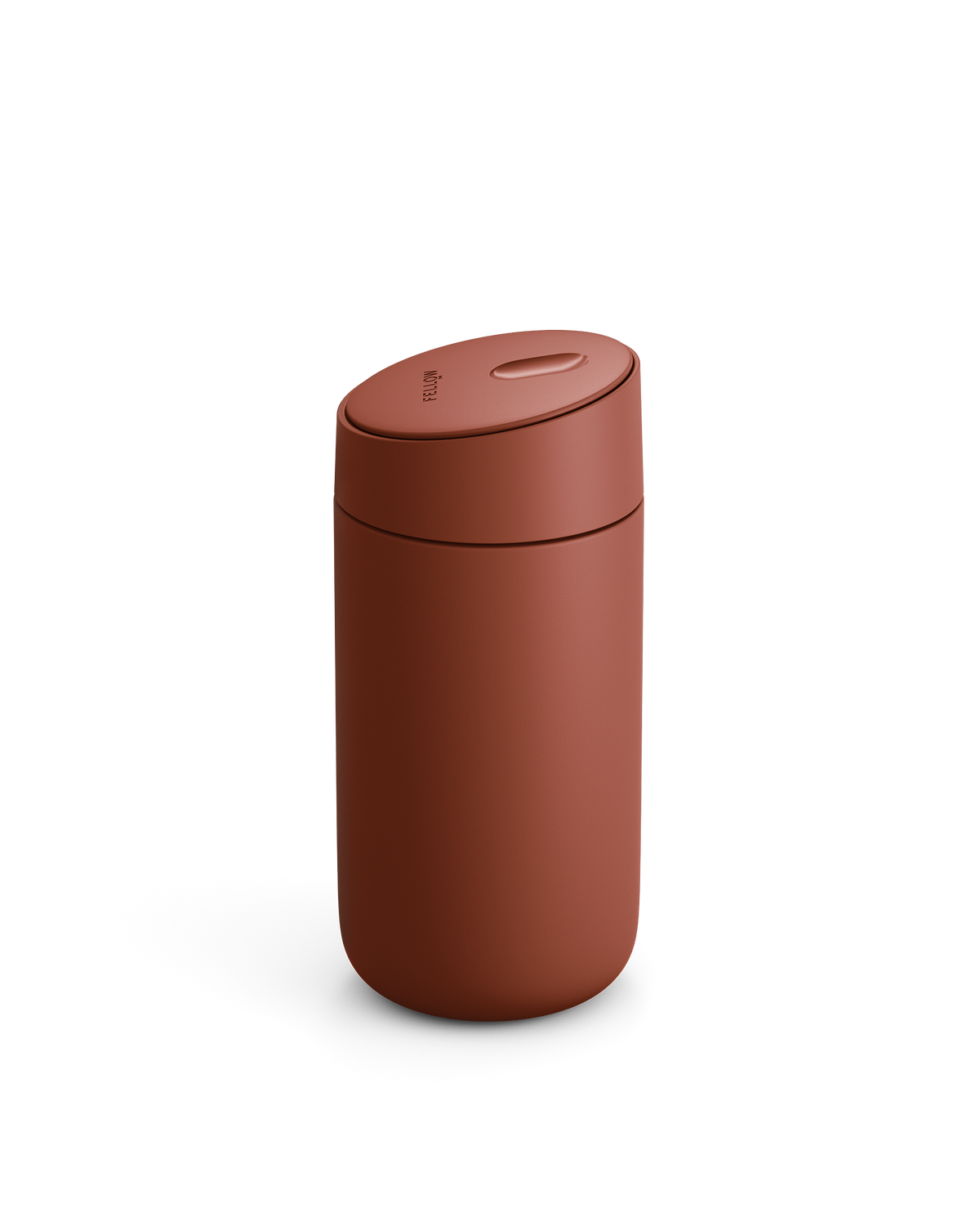 A matte rust-red Carter Slide Mug by Fellow with a rounded lid on a white background.