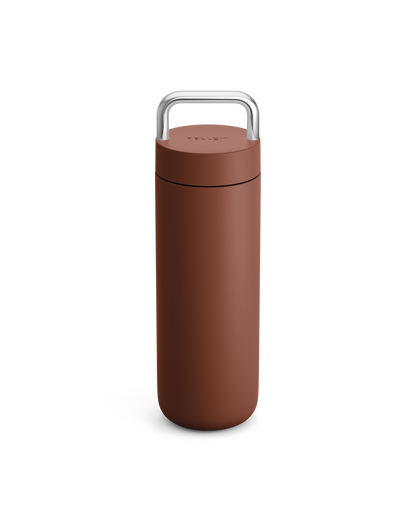 The Fellow Carter Carry Travel Mug in Sienna, shown with silver handle, on a white background.