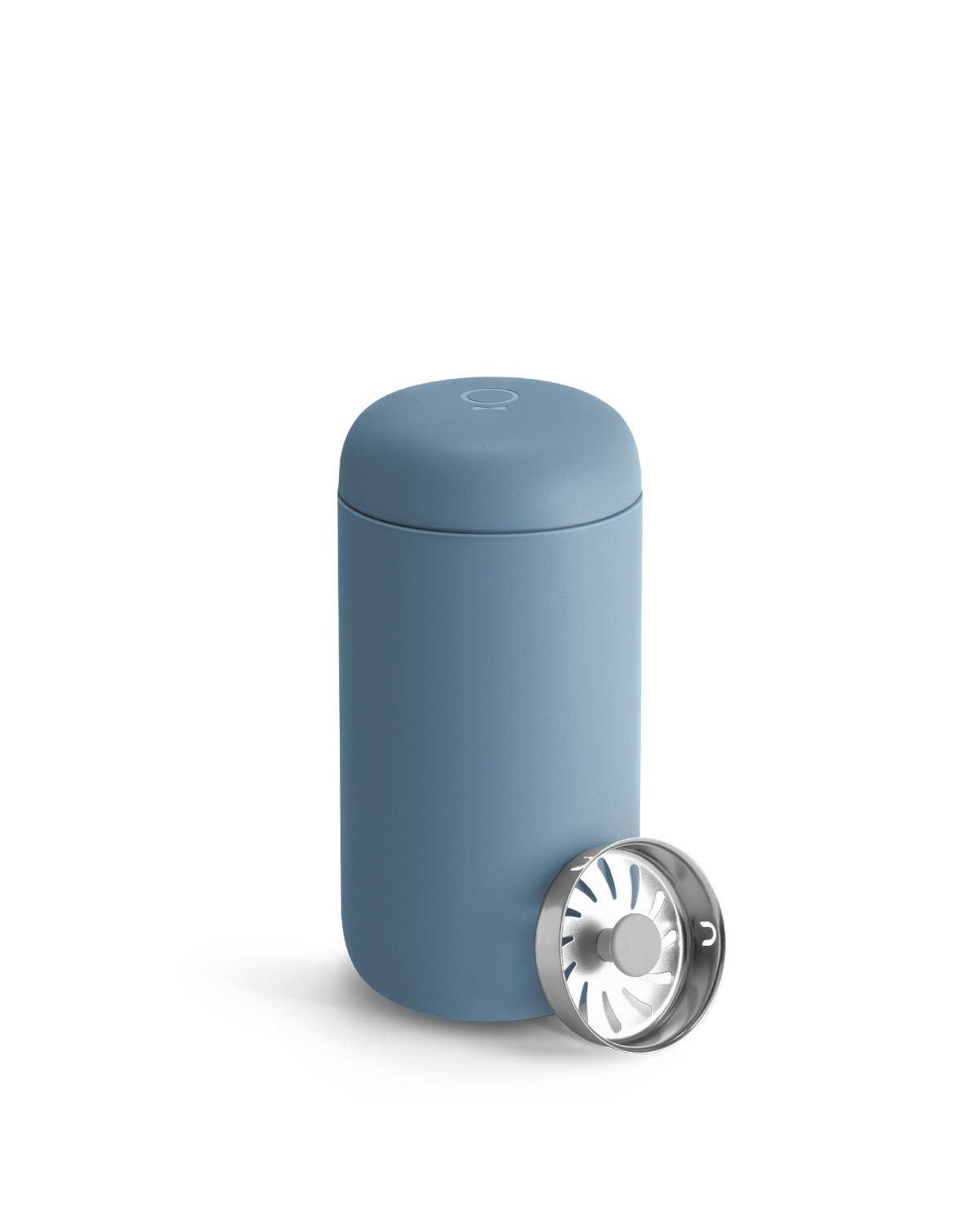 A Fellow Carter Move Mug in blue with a silver strainer lid leaning against it.