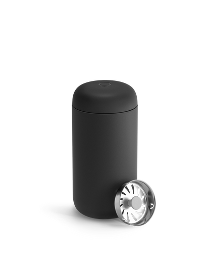 Matte black Fellow Carter Move Mug with rounded lid and separate metal strainer cap.