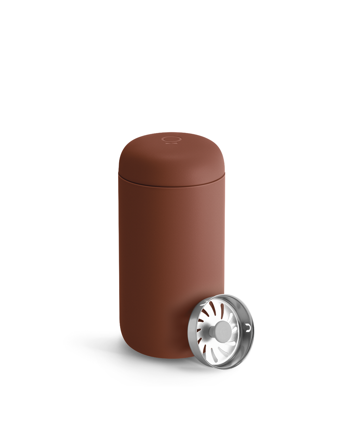 Fellow Carter Move Mug with lid next to a metal part with radial openings.