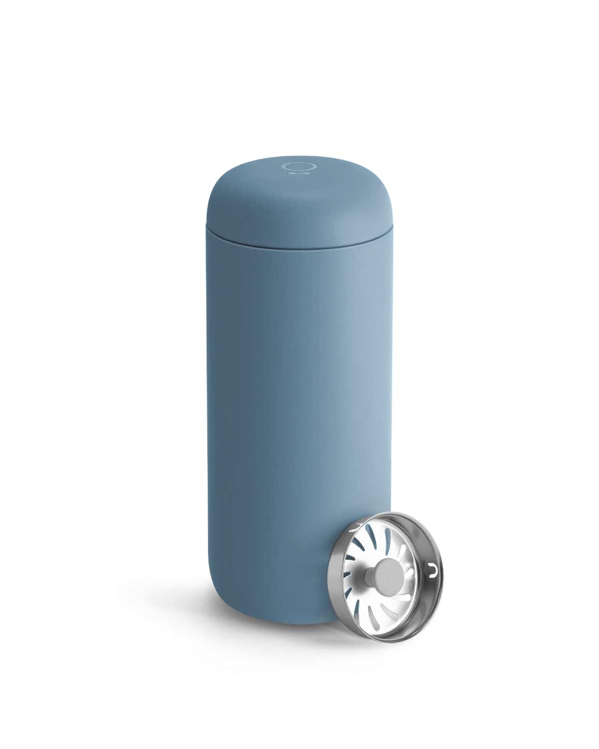 A Fellow Carter Move Mug in blue sits beside its metal strainer on a white background.