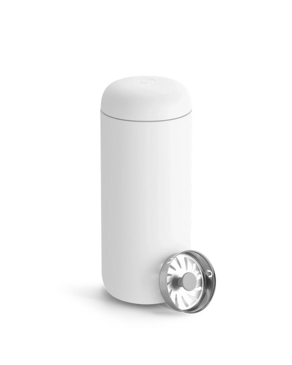 Fellow Carter Move Mug in white, shown with included metal strainer in front.