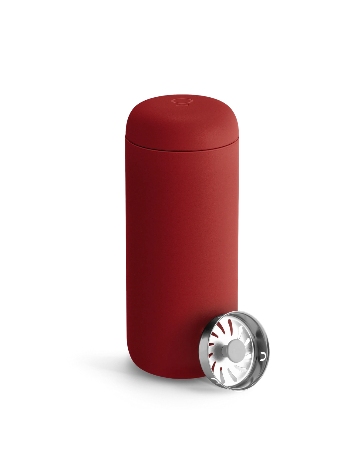 A matte red Fellow Carter Move Mug with a metal strainer on a white background.