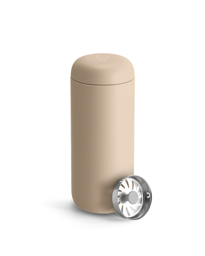 Beige Fellow Carter Move Mug with removable metal strainer on a white background.
