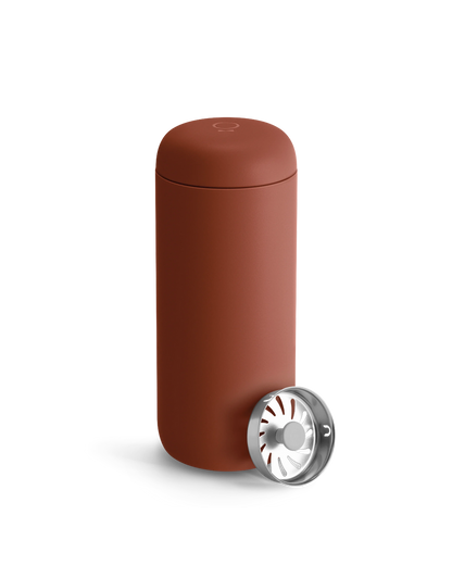 Fellow Carter Move Mug in matte reddish-brown with included metal infuser beside it.