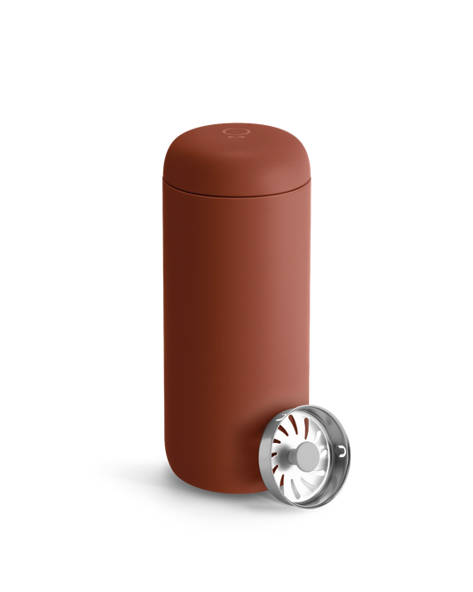 Fellow Carter Move Mug in matte reddish-brown with included metal infuser beside it.