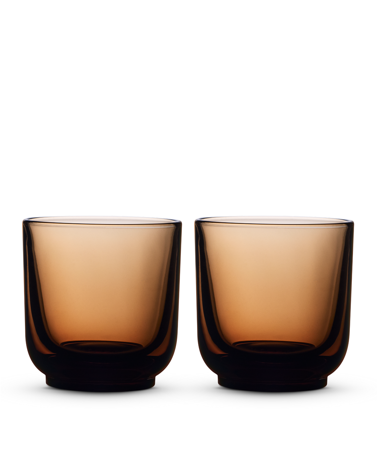 Two brown Pirch Espresso Glasses by Fellow with a modern design on a white background.