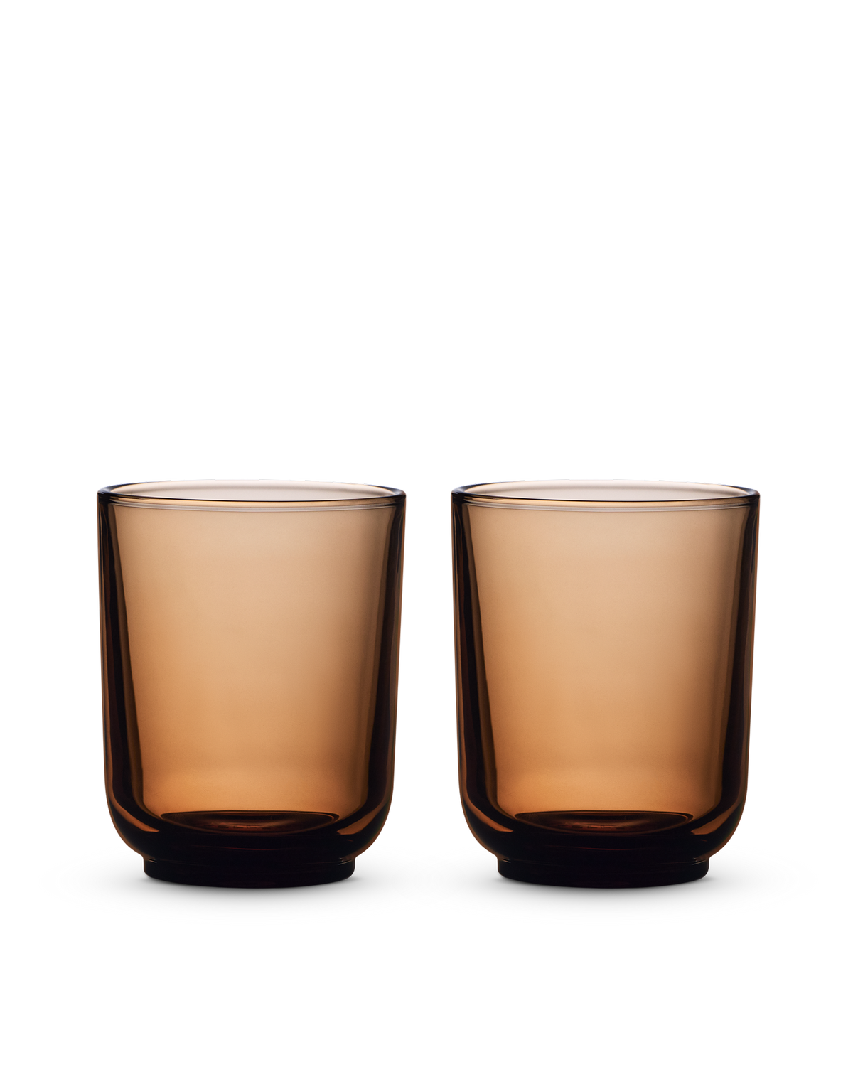 Two Fellow Pirch Espresso Glasses in amber sit on a white background.