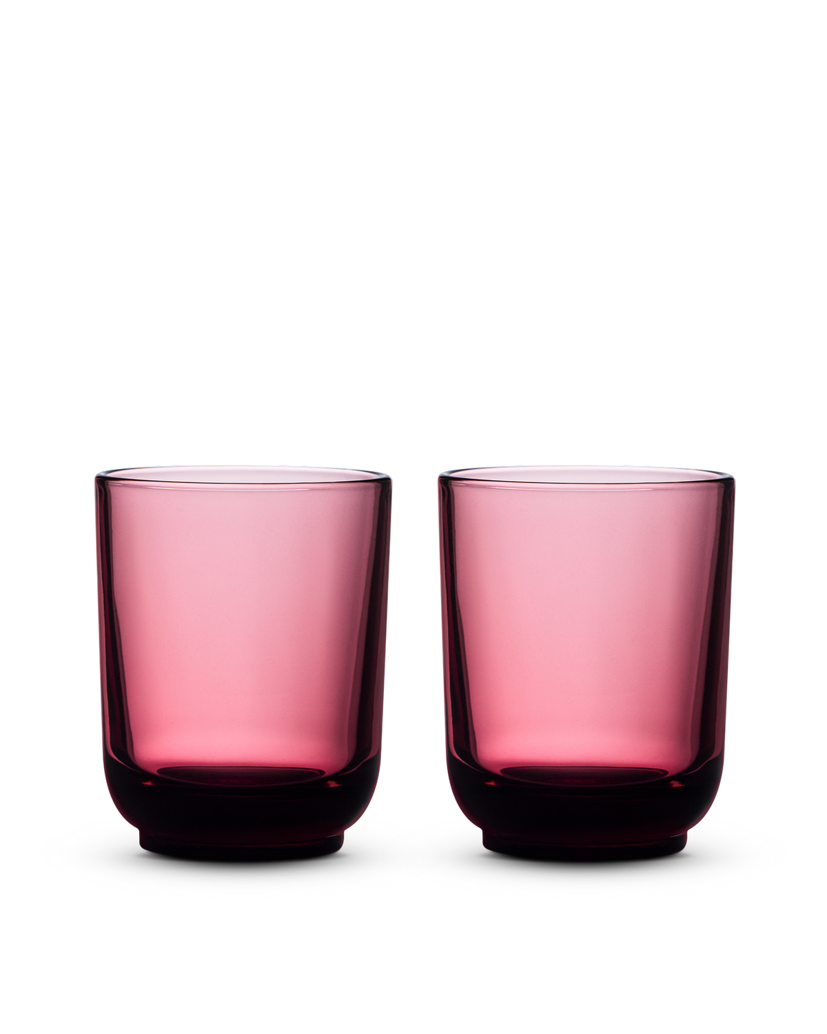 Two Fellow Pirch Espresso Glasses in pink displayed on a white background.