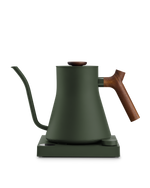 Fellow Stagg EKG matte green electric kettle with wood handle, gooseneck spout, and base.