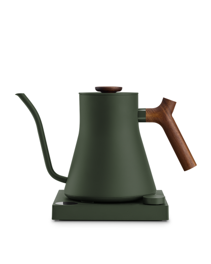 Fellow Stagg EKG matte green electric kettle with wood handle, gooseneck spout, and base.
