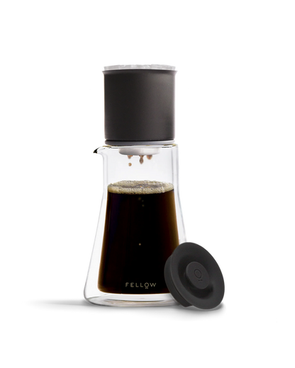 Fellow Stagg [XF] Pour-Over Set with black filter, lid, and coffee in the carafe.