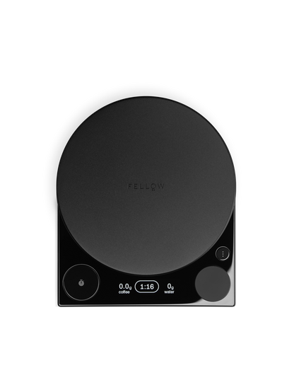 The Fellow Tally™ Pro Studio is a black coffee scale with a round platform and lit digital display.