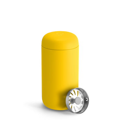 A Fellow Carter Move Mug in Lemon Zest with insulation and removable silver strainer lid.