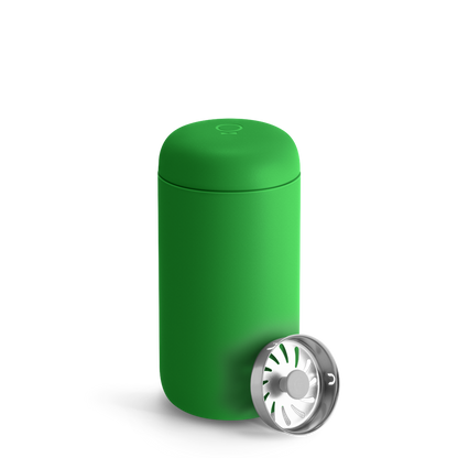 A Sporty Green Fellow Carter Move Mug with metal infuser lid beside it.
