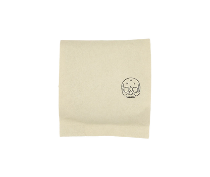 A beige Monarch napkin with skull and crossbones—perfect for your Onyx Coffee Lab coffee.